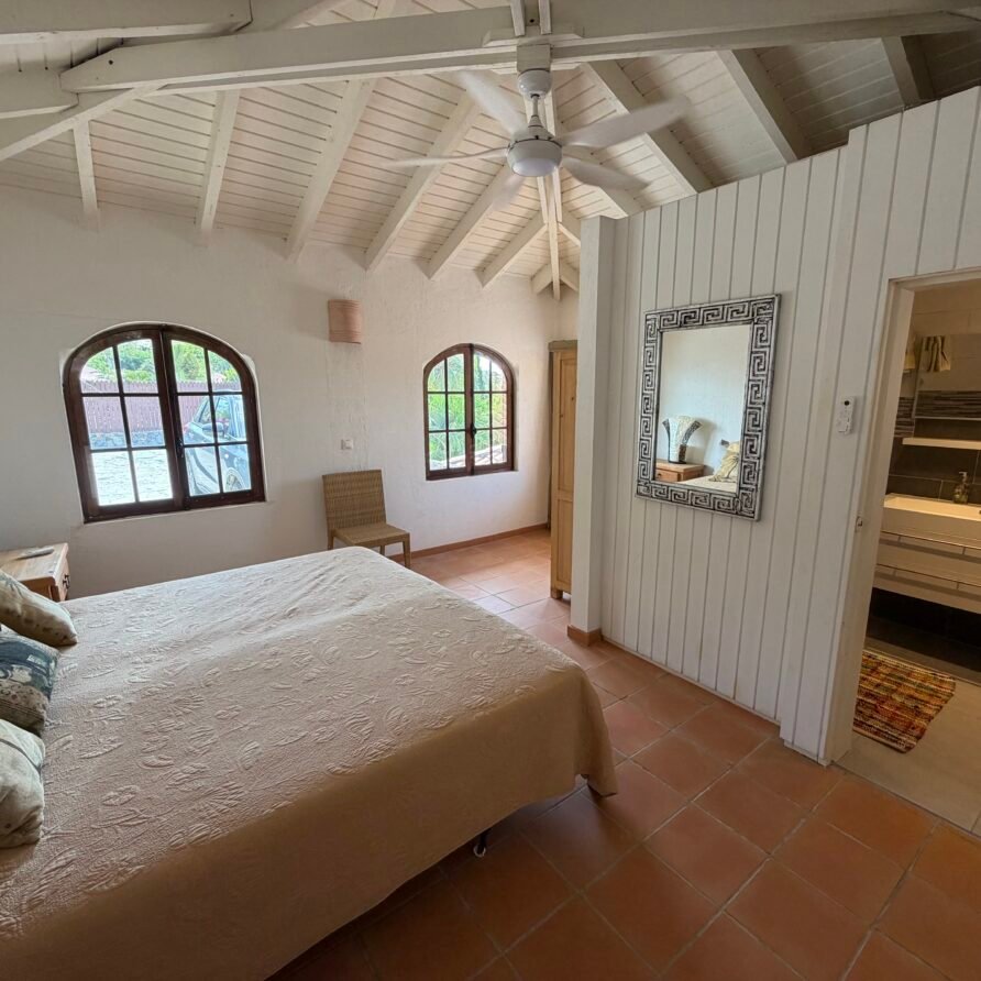 Elegant open-plan living area with high ceilings and direct access to the upper sun deck.