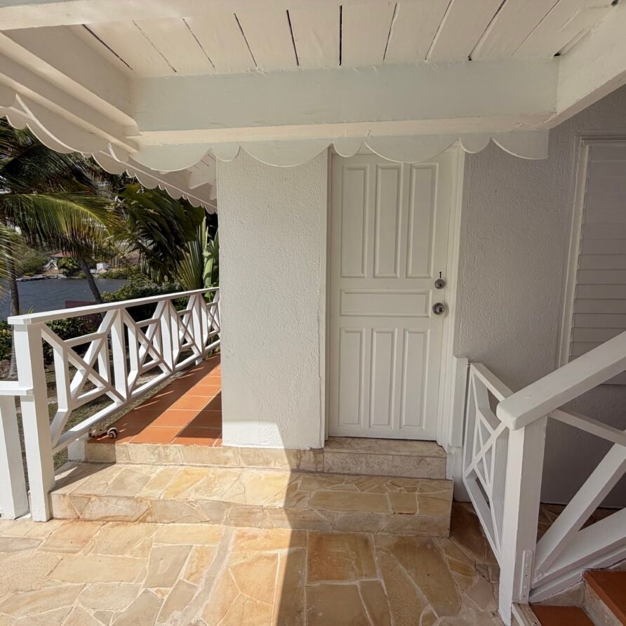 Spacious waterfront villa with a large pool deck, lounge chairs, and panoramic sea views.