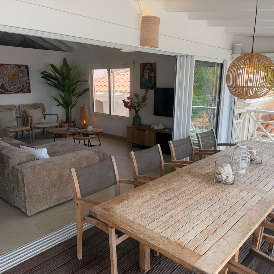 Waterfront outdoor dining and sun deck with panoramic views over Oyster Pond and the sea.