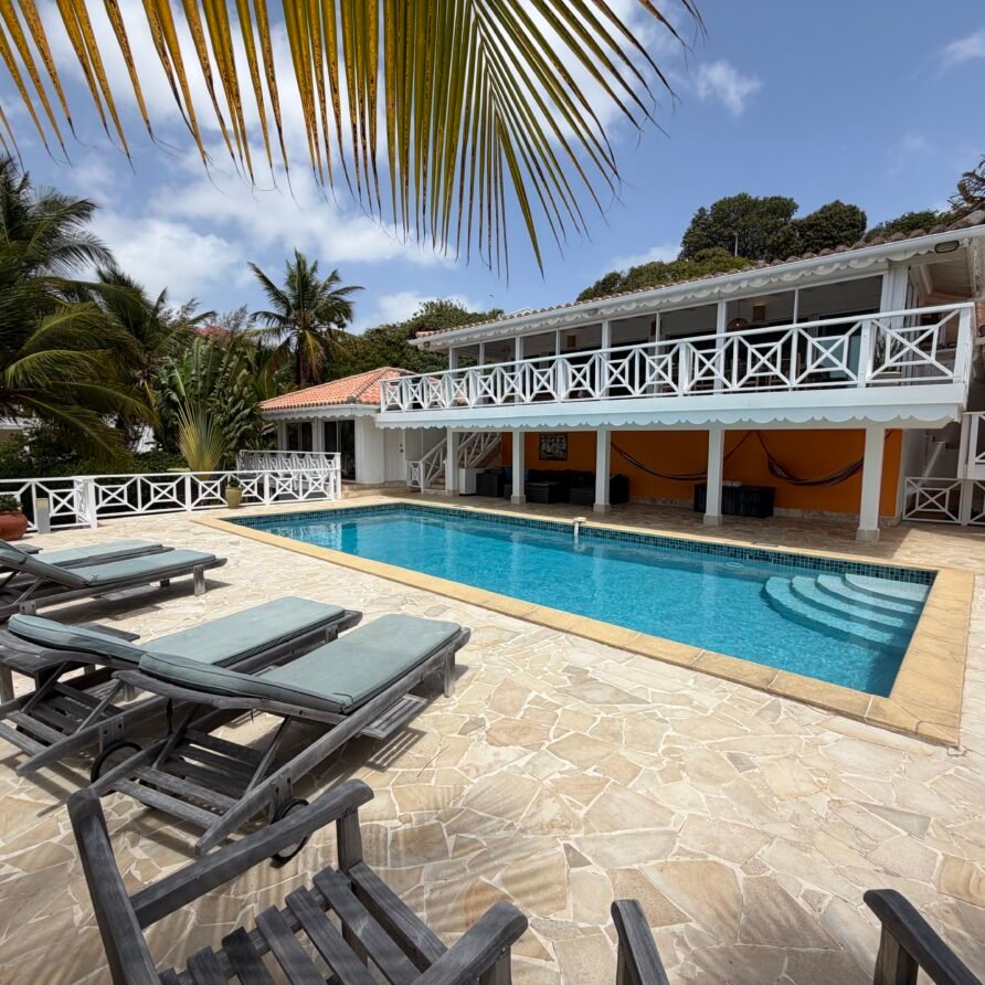 Elegant open-plan living area with high ceilings and direct access to the upper sun deck.