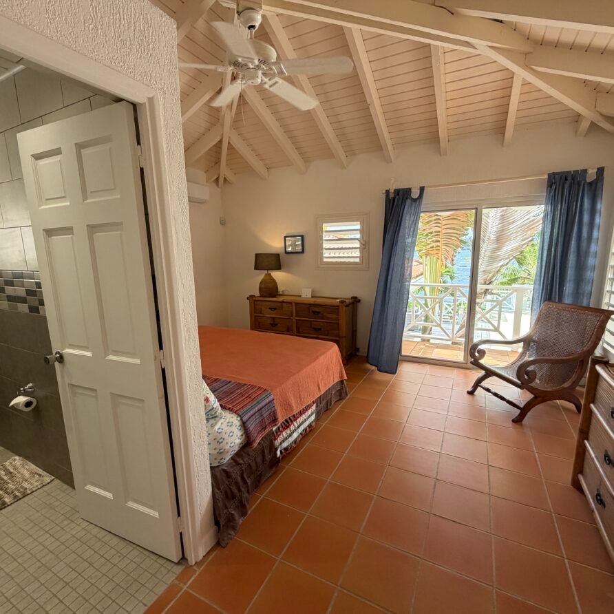 Villa Coralita exterior with private dock, swimming pool, and expansive Caribbean waterfront views.